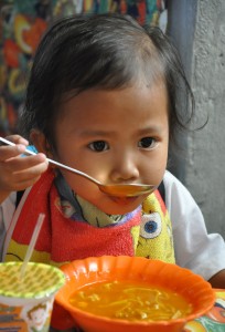 Day Care Child Kate Salabsab during the Supplementary Feeding Program  in Camestizoan Day Care Center