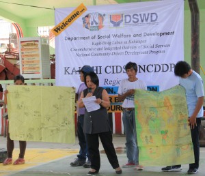 Aida presents an oration piece and her drawings depicting their barangay’s need for an access road during the sub-project prioritization in Bagulin, La Union.