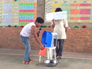Community volunteers portray their need for a water system, showcasing the problems that arise due to the insufficient supply of clean water in their barangay.