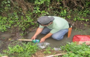 Barangay Captain Freddie Pecsoy helping the volunteers in measuring the amount of water discharge from the proposed water source in Sitio Demang Brgy. Lipay Este, San Gabriel, La Union  during the Site Validation for the proposed water system subproject.