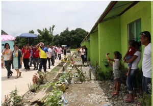 L-R: Rosales Mayor Susan P. Casareno, Asst. Secretary Hope V. Hervilla; 2nd Row: Dir. Marcelo Nicomedes J. Castillo, and Bureau Director Pacita D. Sarino while inspecting the row houses at San Pedro West, Rosales, Pangasinan. 