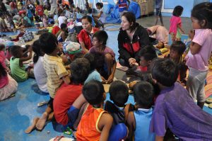 Children evacuees at Aringay Amphitheater, Aringay, La Union gathered for psychosocial support processing (PSP) conducted by Social Workers Maricel Caleja and Ryleen Gadong.